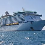 Guides & Tips 7 A luxurious cruise ship sailing on the ocean under a clear blue sky, ideal for travel and leisure.