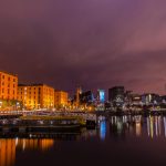 Stunning view of Liverpool's Albert Dock with cityscape reflections at dusk.