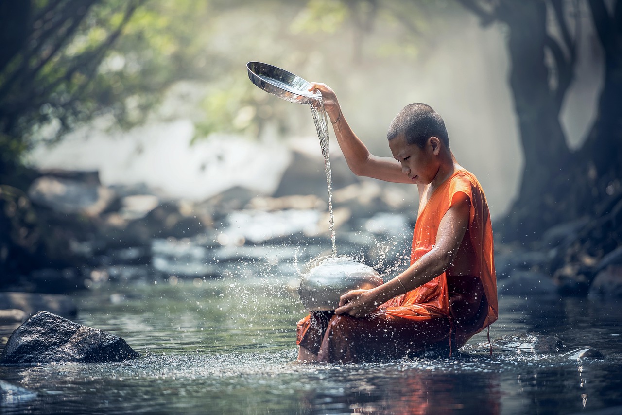 Young monk in water in Thailand